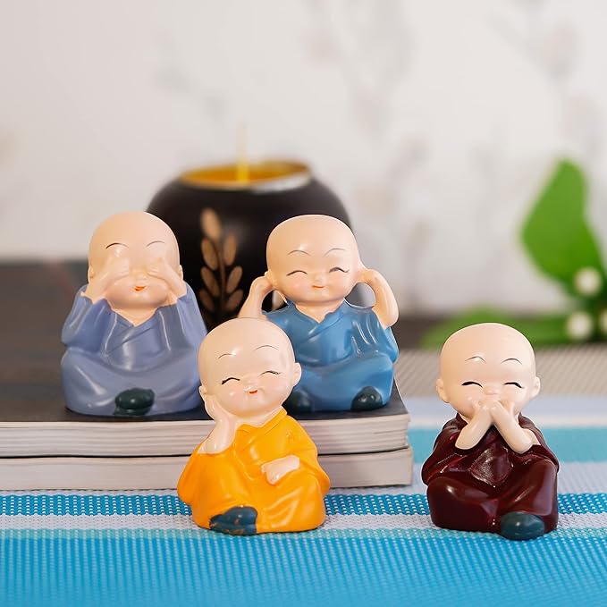 Set of four cute monk figurines in meditation poses, symbolizing wisdom, peace, happiness, and positivity, perfect for home décor, office desks, and gift hampers.
