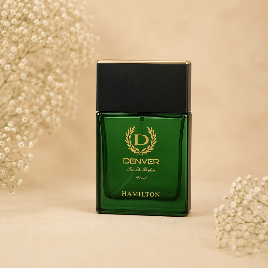 A green rectangular perfume bottle with a black cap and gold lettering, reading 'DENVER Eau De Parfum' and 'HAMILTON'.