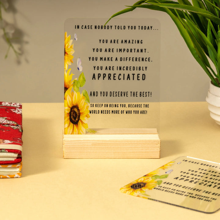 Stack of motivational Acrylic with sunflower design on a yellow surface