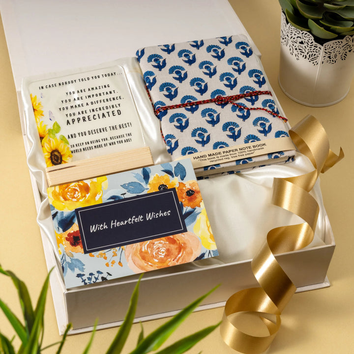 Gift set with floral notebook and card in a box on a yellow background