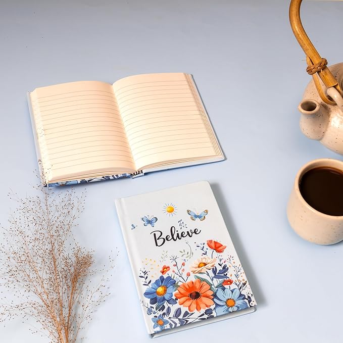 Blue floral inspirational diary with a “Believe” cover design, featuring colorful flowers and butterflies, part of an Evil Eye themed gift hamper.