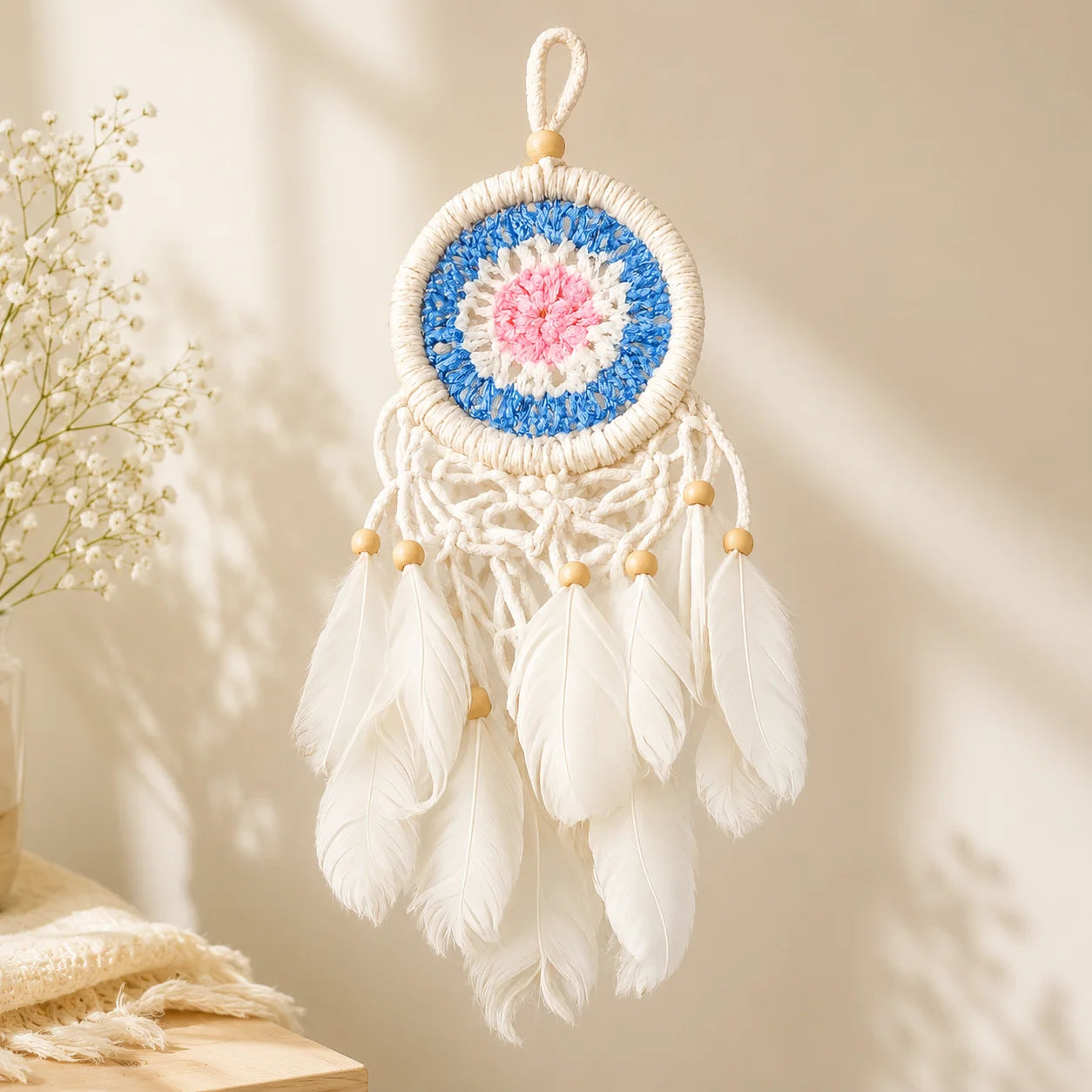 Handmade white and blue dreamcatcher with feathers and macramé detailing for gifting