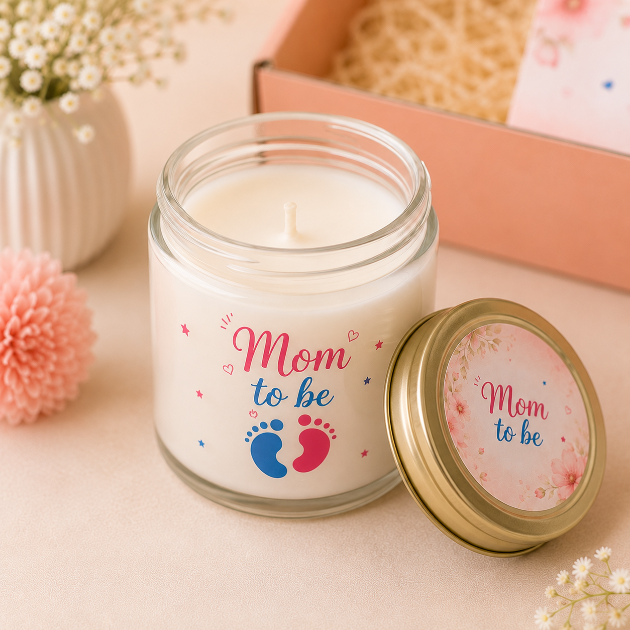 Personalized "Mom To Be" scented soy candle in a clear glass jar with a gold lid, styled in a professional pastel product photography setup.