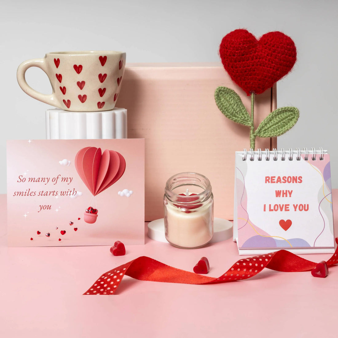 Premium Rarejoy Valentine's gift hamper with a heart-pattern ceramic mug, handmade crochet heart flower, scented candle, 'Reasons Why I Love You' notebook, and personalized greeting card, ideal for Valentine's Day, anniversaries, birthdays, and romantic gifts for her