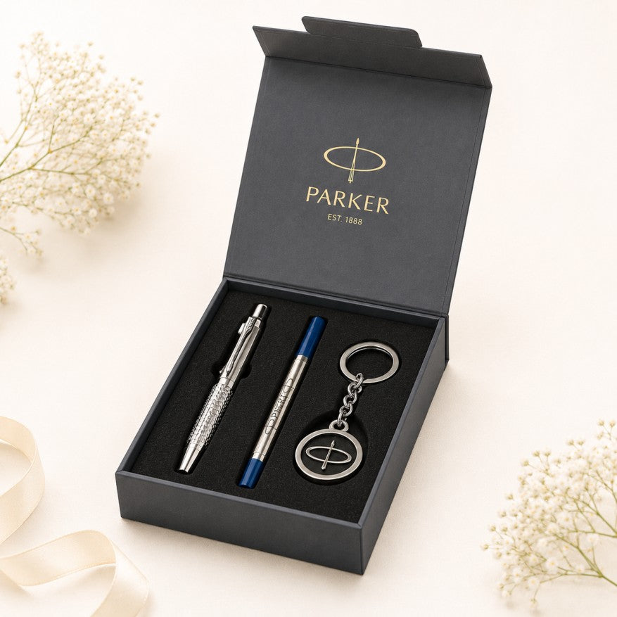 A Parker gift set in an open black presentation box, containing a silver ballpoint pen, a blue and silver ballpoint pen, and a matching silver keychain.